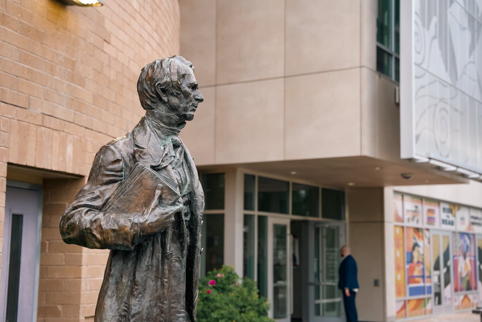 A bronze statue of a man holding a book stands outside the Anchorage Assembly building during a summer meeting in Anchorage, Alaska.