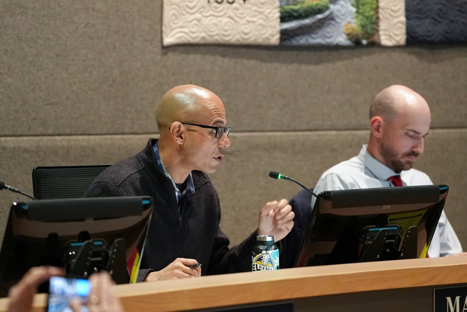 A bald man with glasses speaks into a microphone during an Anchorage Assembly meeting held in Anchorage, Alaska, on June 23, 2026.