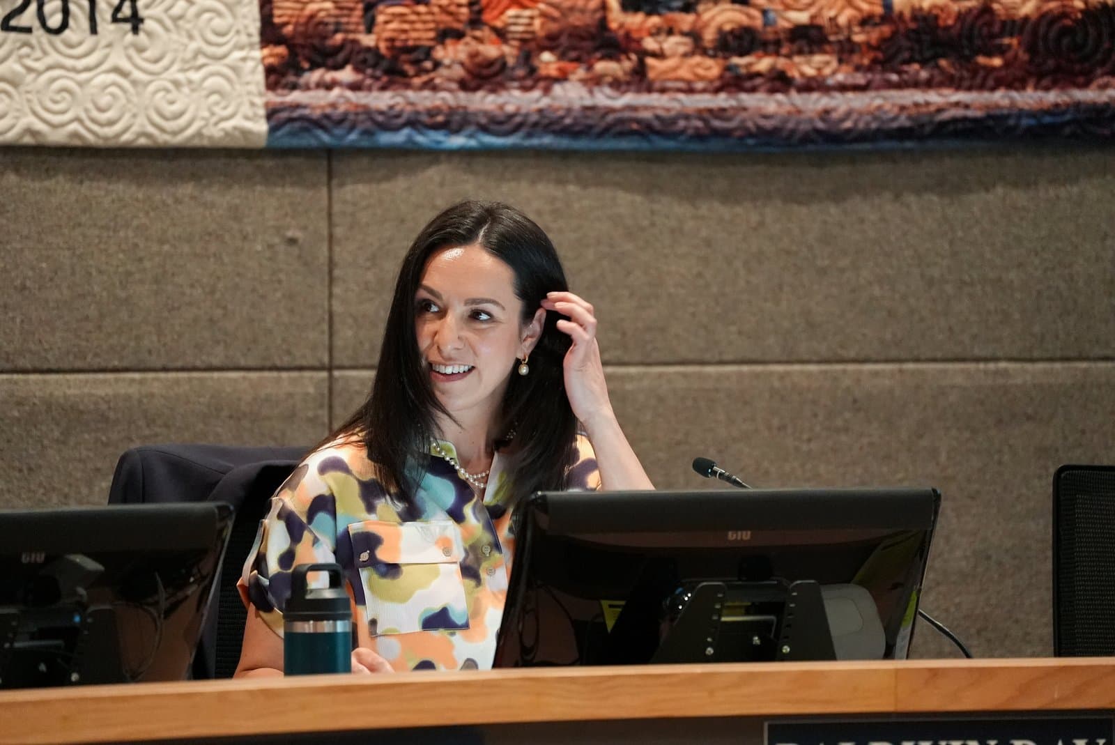 Midtown Anchorage Assembly Member Erin Baldwin Day adjusting her hair at the assembly meeting