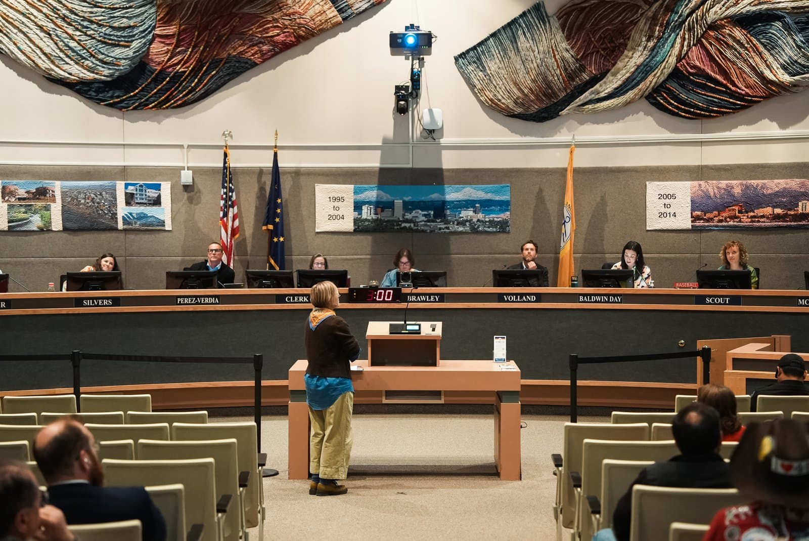 A citizen provides public testimony at a podium during an Anchorage Assembly meeting held in the municipal chambers in Anchorage, Alaska.