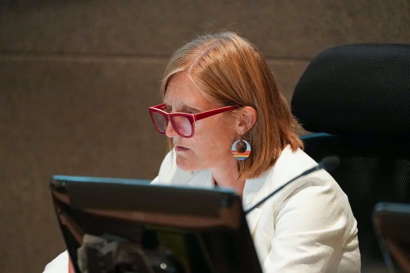An Anchorage Assembly member reviews documents on a computer screen during a public meeting held in Anchorage, Alaska, on June 23, 2026.