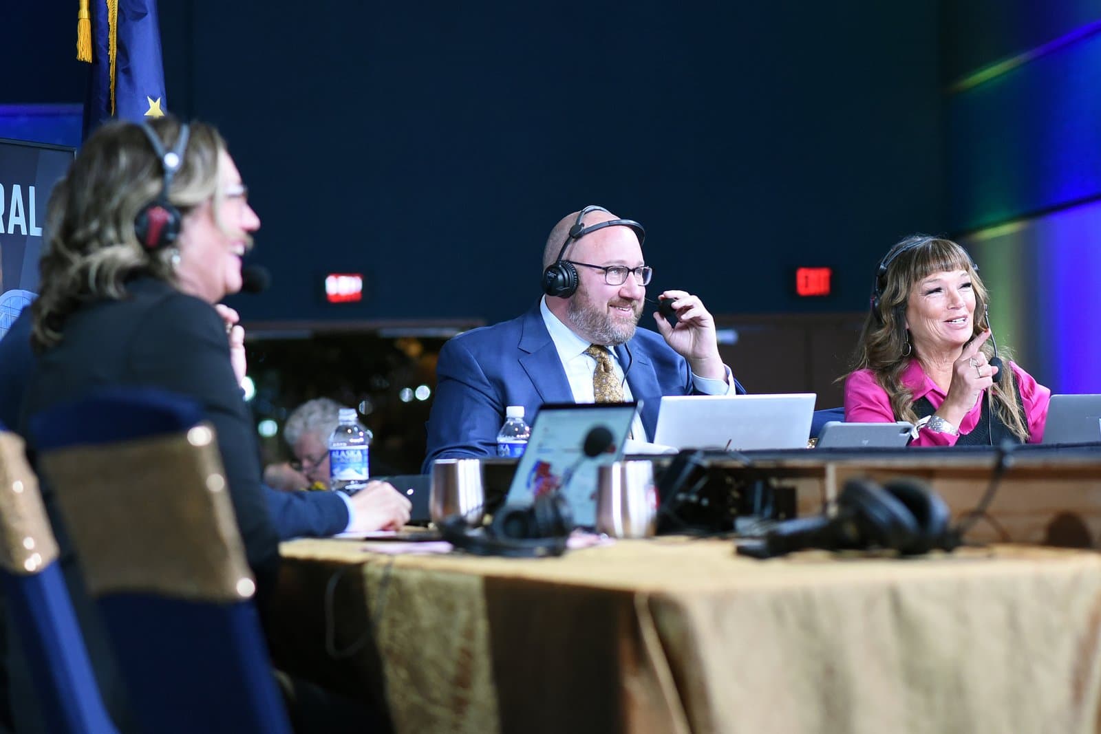 Three people wearing headsets participate in an election night broadcast at Election Central in November 2024.