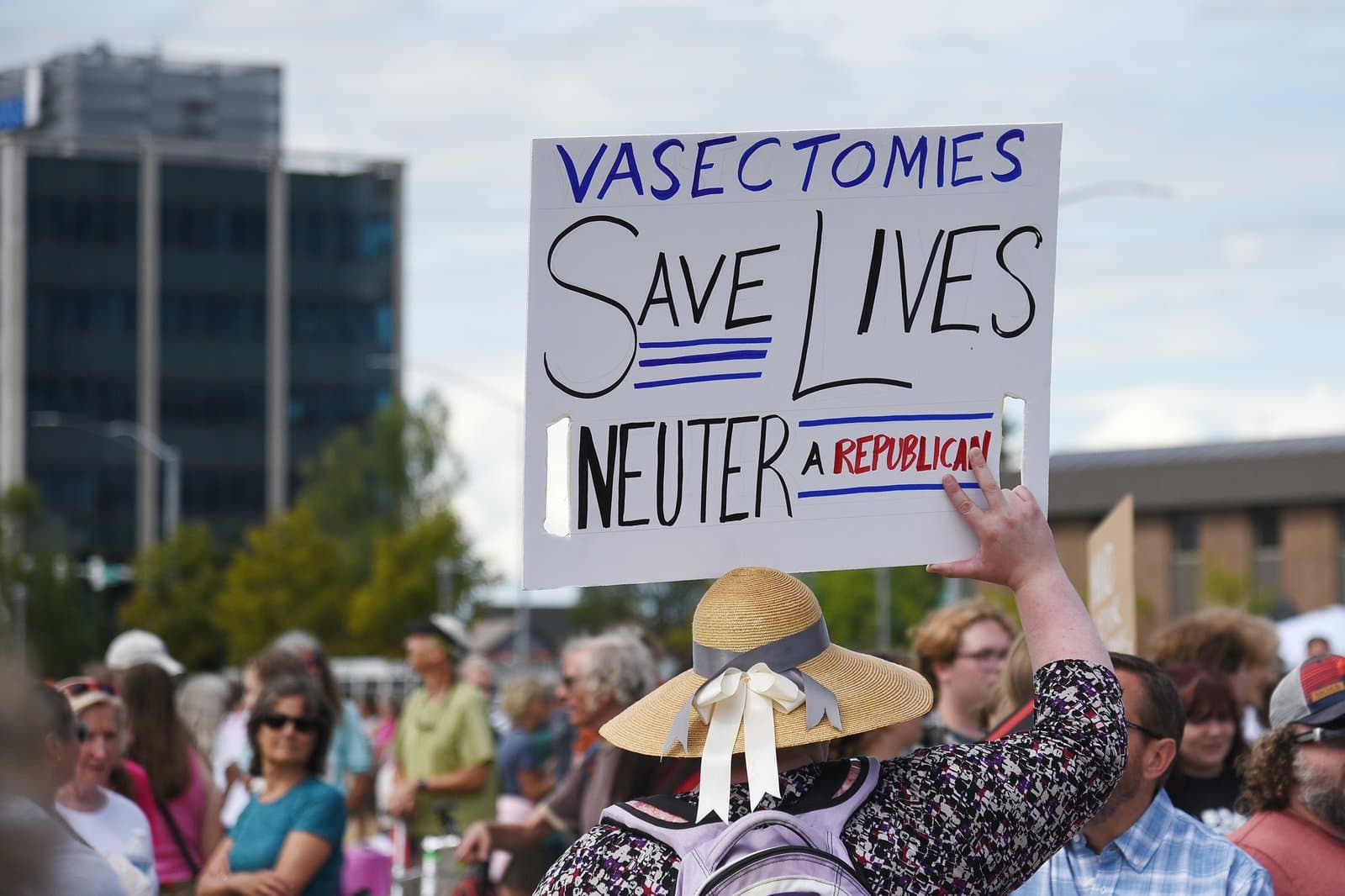 A protester holds a sign reading Vasectomies Save Lives during a Planned Parenthood rally in downtown Anchorage, Alaska, on July 9, 2022.