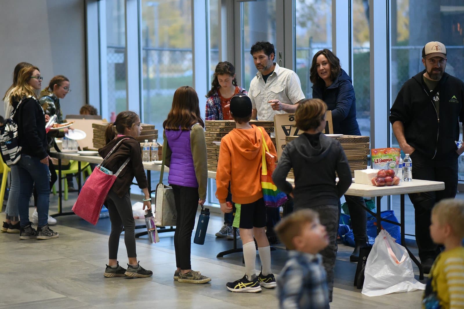 Community members gather around tables with pizza boxes during an Anchorage Assembly meeting held in October 2021 in Anchorage, Alaska.