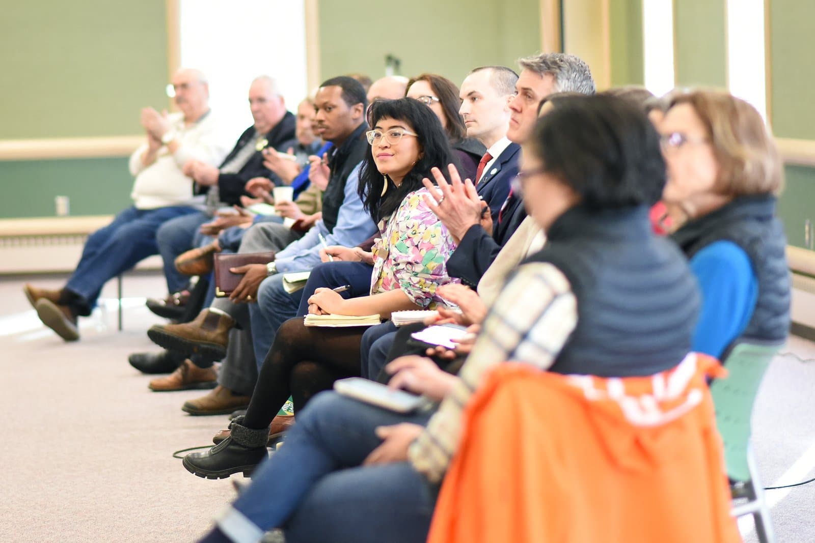Attendees listen attentively during the 2024 Anchorage Legislative Town Hall held in an indoor community space in Anchorage, Alaska.