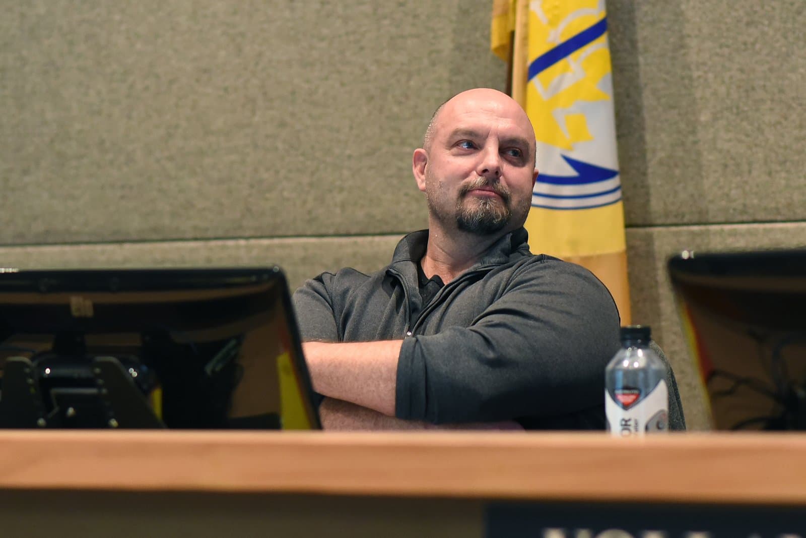 Kevin Cross sits at a desk with arms crossed while announcing his resignation from the Anchorage Assembly in Anchorage, Alaska.