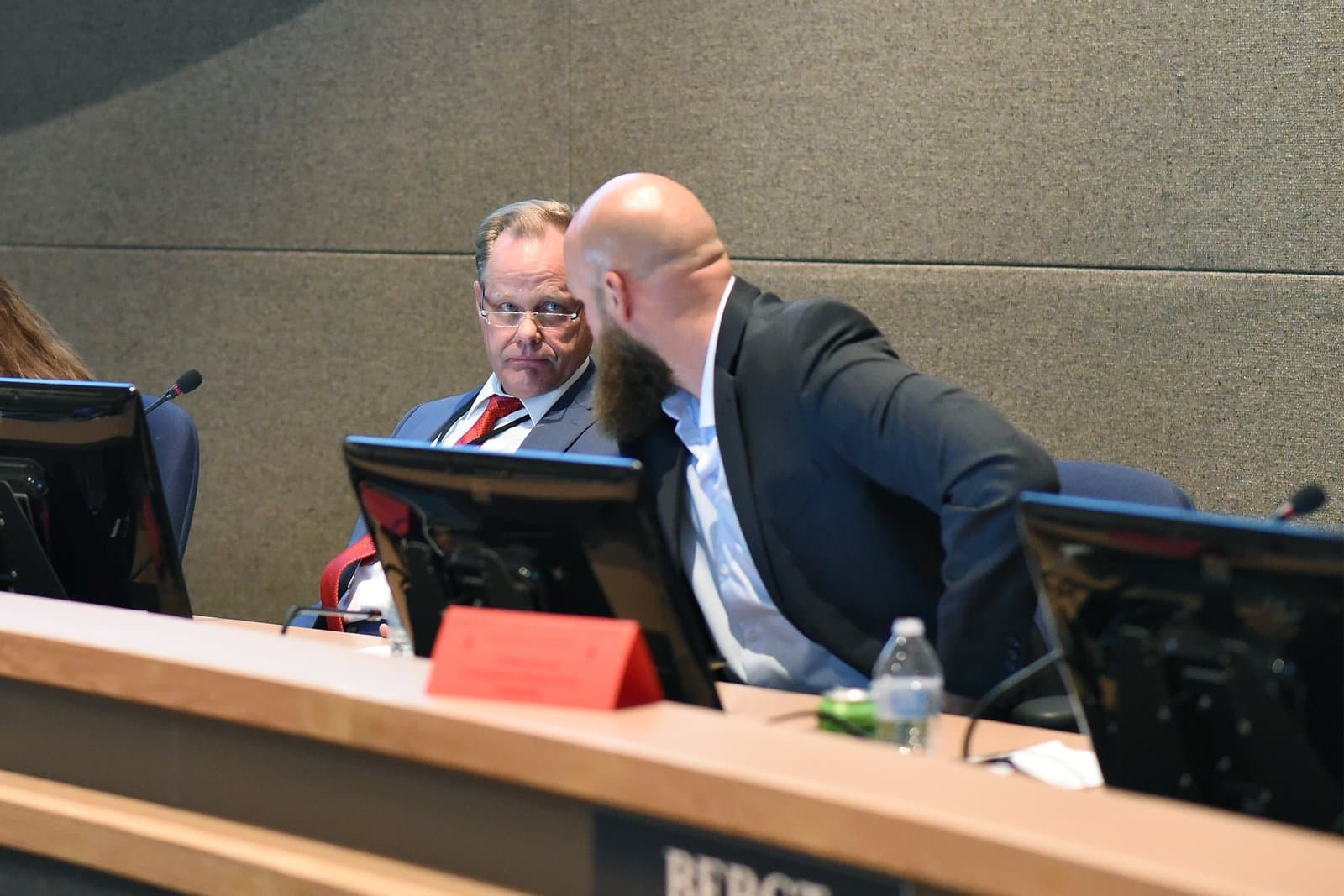 Two men converse at a desk during an Anchorage Assembly meeting held in October 2021 in Anchorage, Alaska.