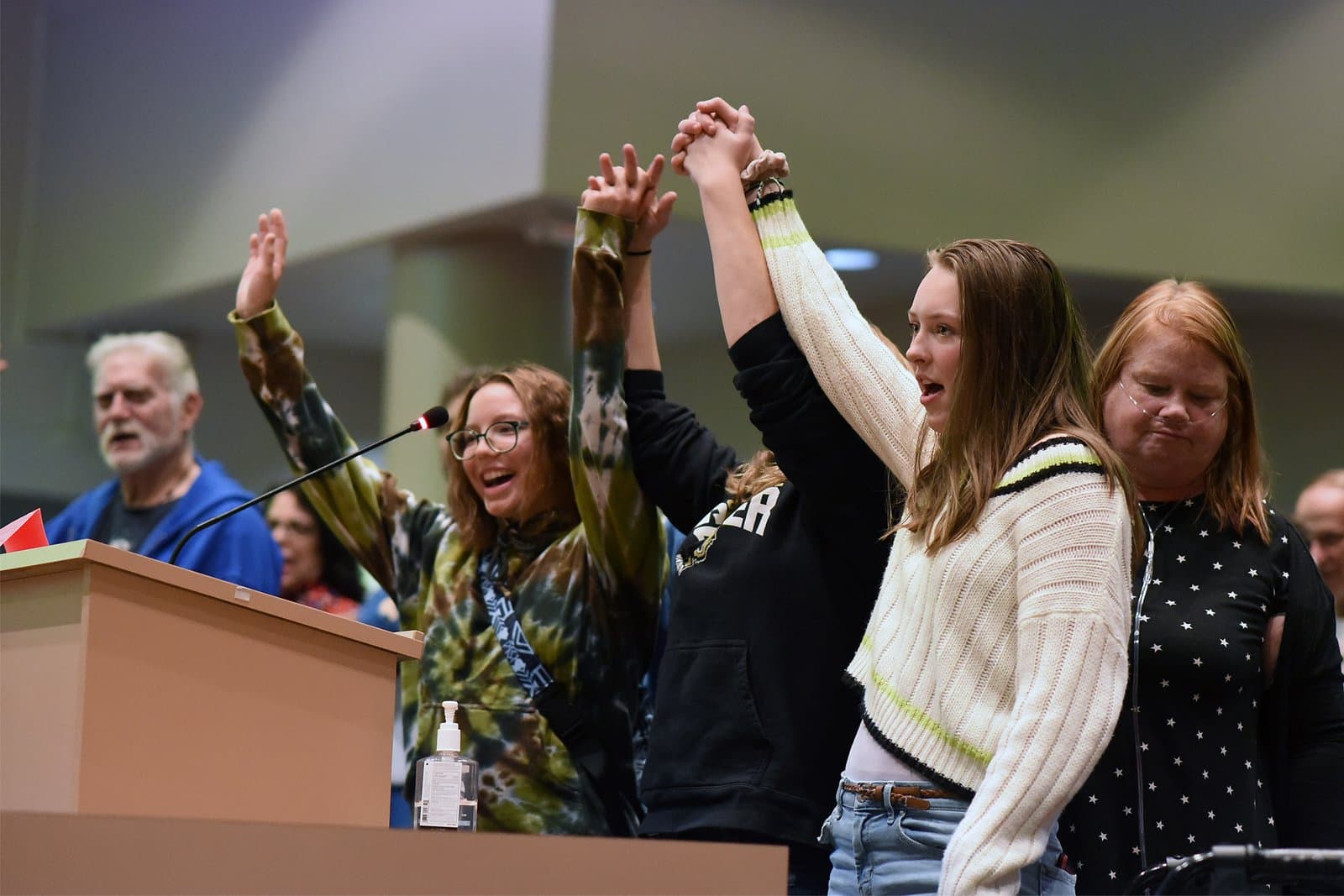 Young people raise their hands in solidarity while speaking at an Anchorage Assembly meeting held in October 2021.