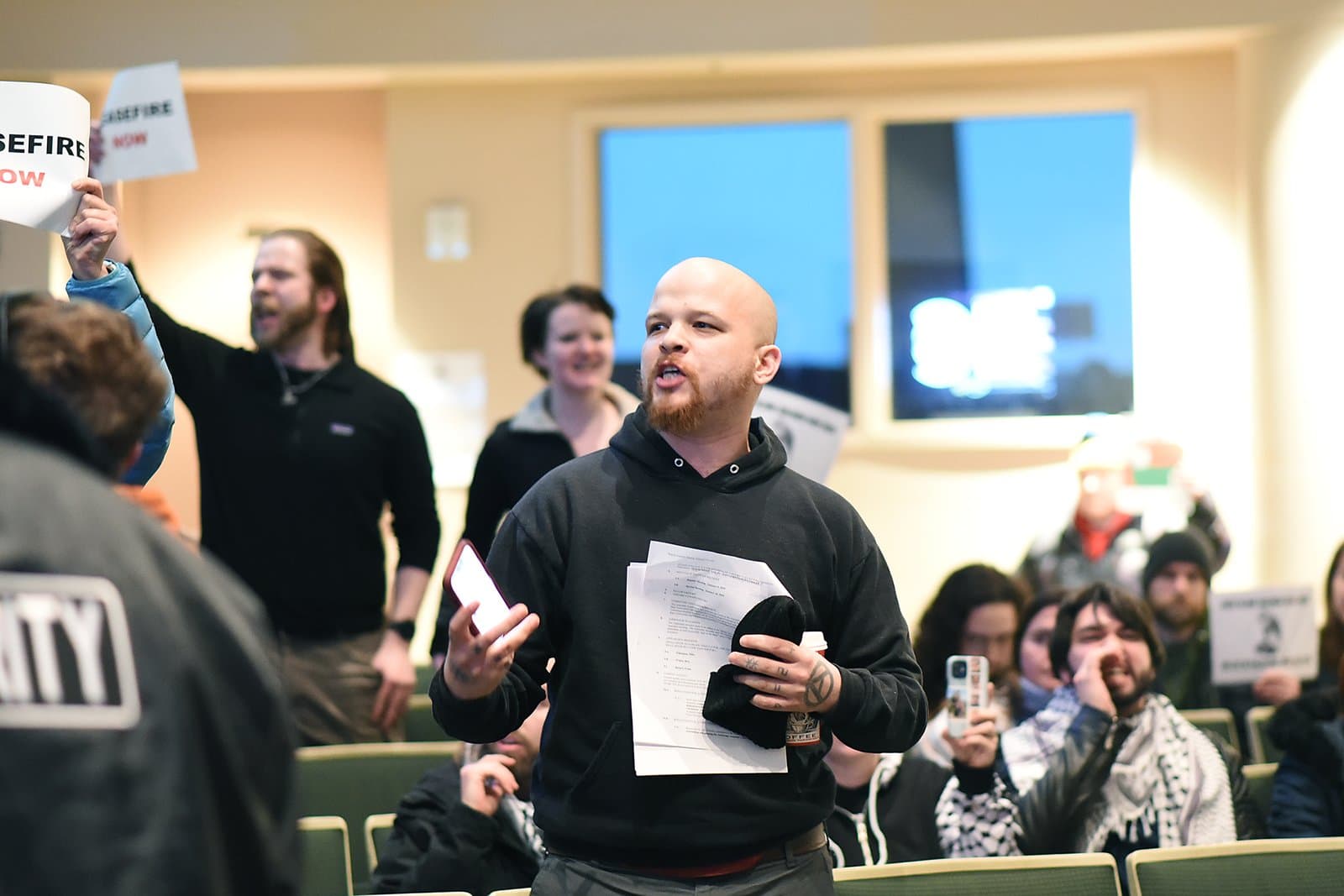 Michael Patterson speaks while holding papers during a public disruption at an Anchorage Assembly meeting in Anchorage, Alaska.