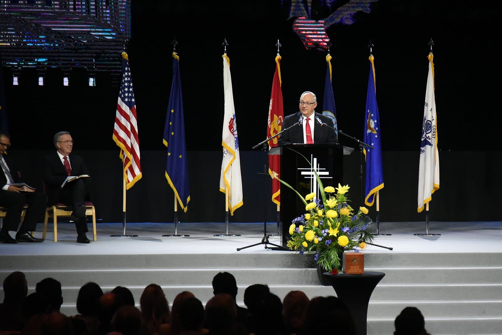 A speaker addresses attendees from a podium during the memorial service for Congressman Don Young in Washington D.C.