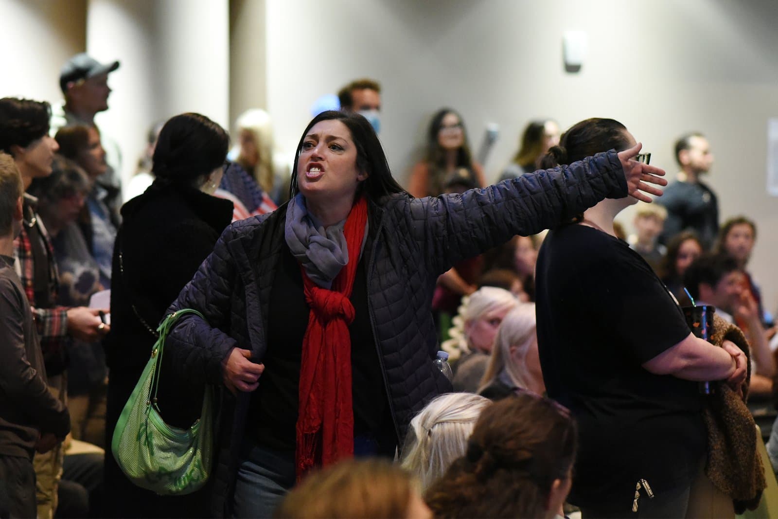 A woman gestures and speaks passionately while addressing the Anchorage Assembly during a public meeting held in October 2021.