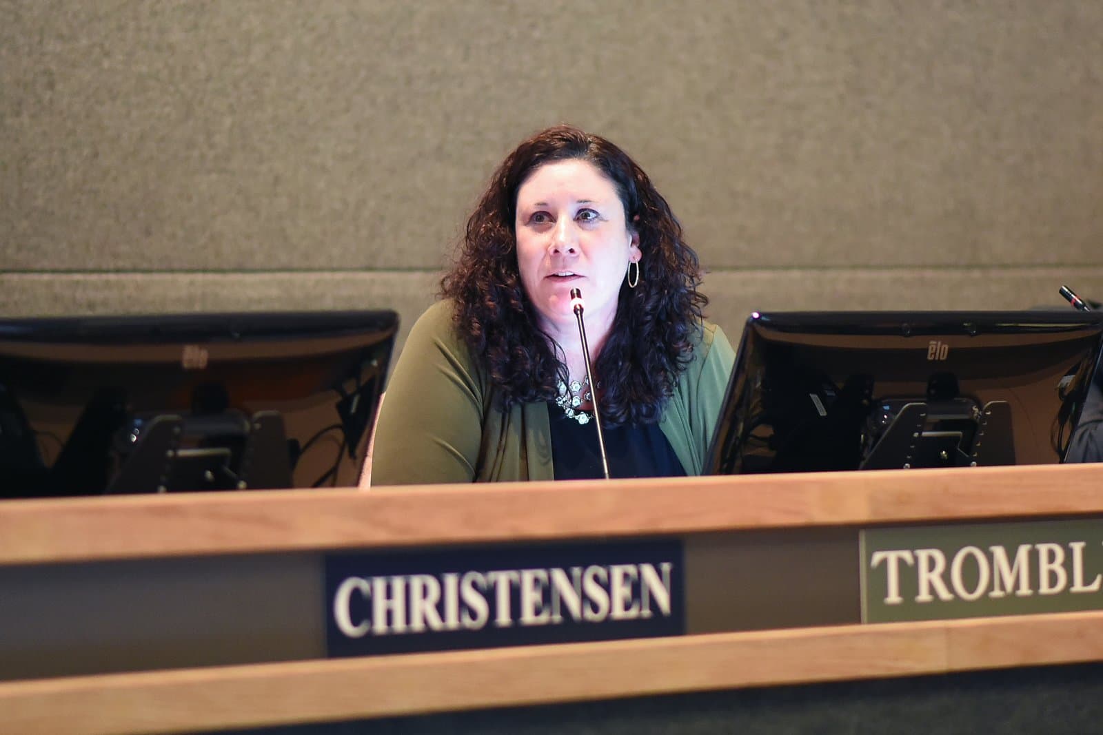 Acting Anchorage Municipal Attorney Blair Christensen speaks into a microphone during a public meeting at the Anchorage City Hall.