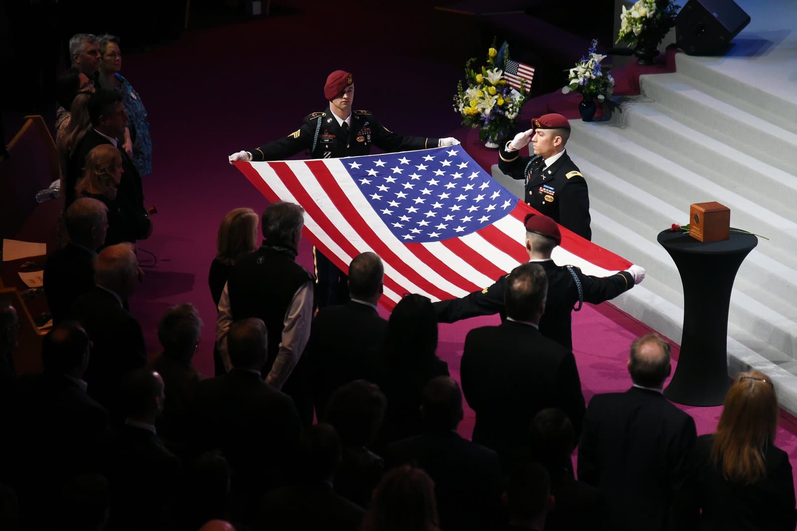 Military honor guard members hold an American flag during the memorial service for Congressman Don Young in Washington D.C.