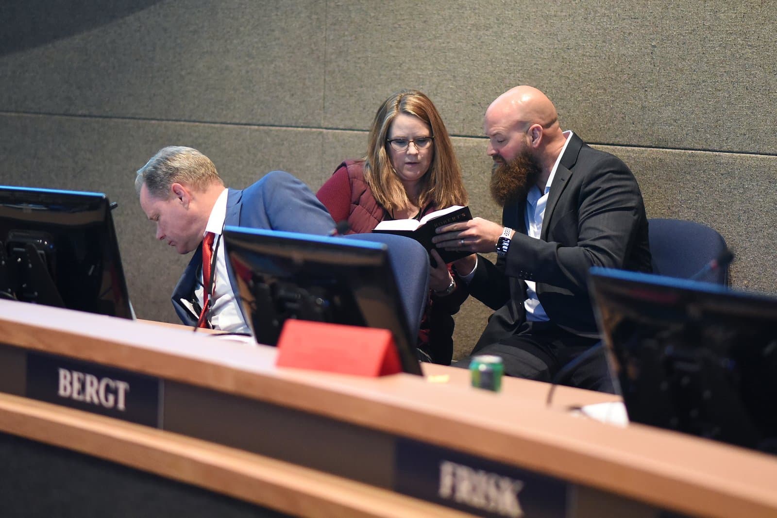Anchorage Assembly members Bergt and Frisk review a copy of Robert's Rules of Order during a public meeting in Anchorage, Alaska.