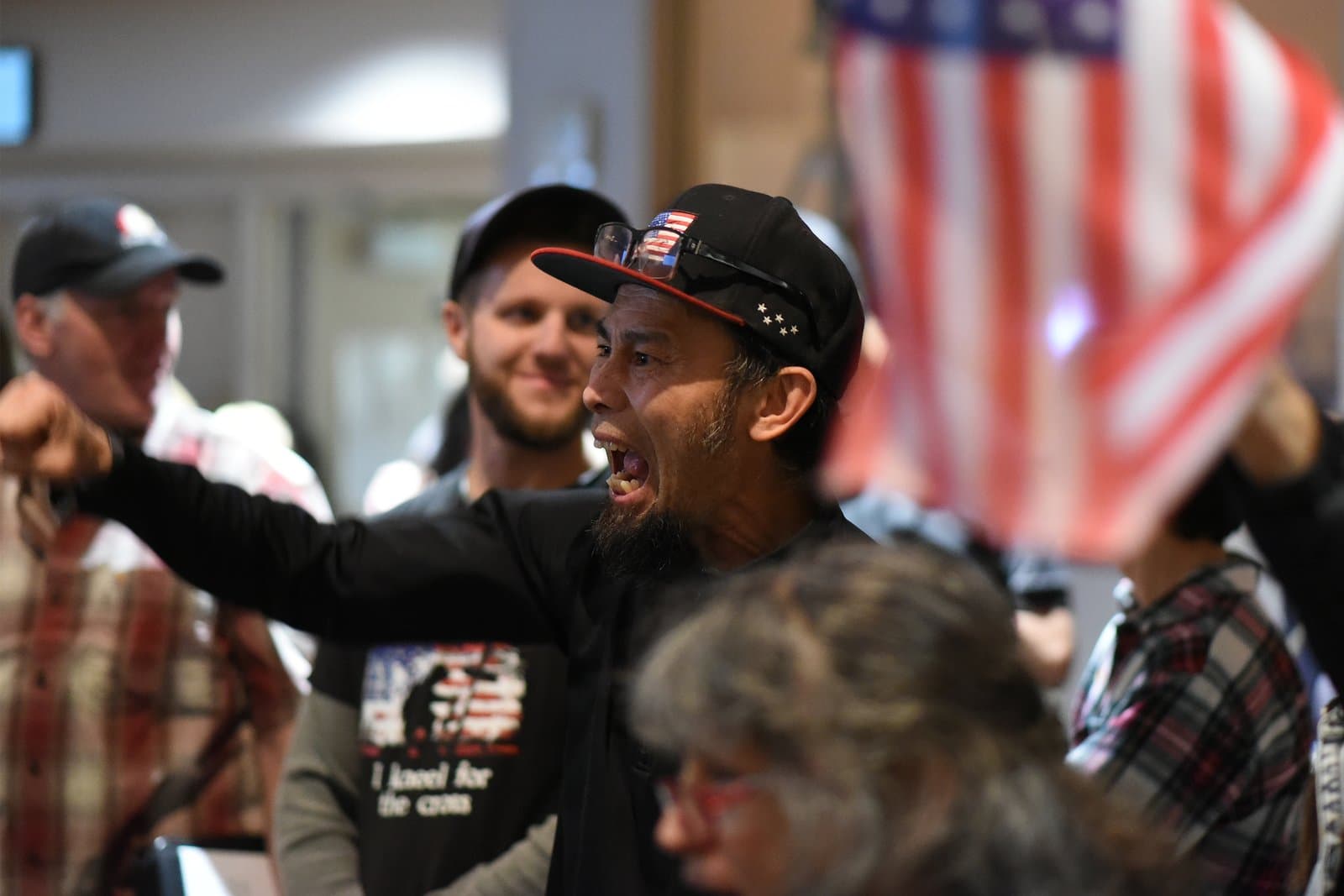 A man speaks passionately during an Anchorage Assembly meeting in October 2021, with other attendees visible in the background.