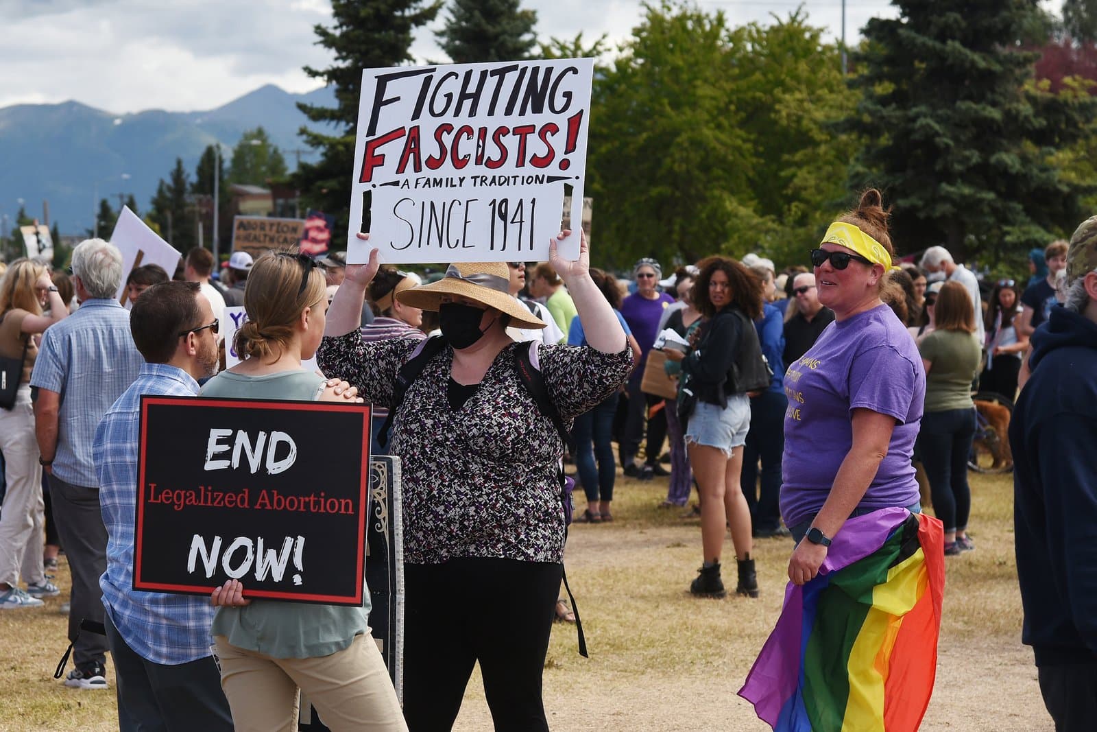 Protesters hold signs during a Planned Parenthood rally in downtown Anchorage, Alaska, on a sunny summer day in July 2022.