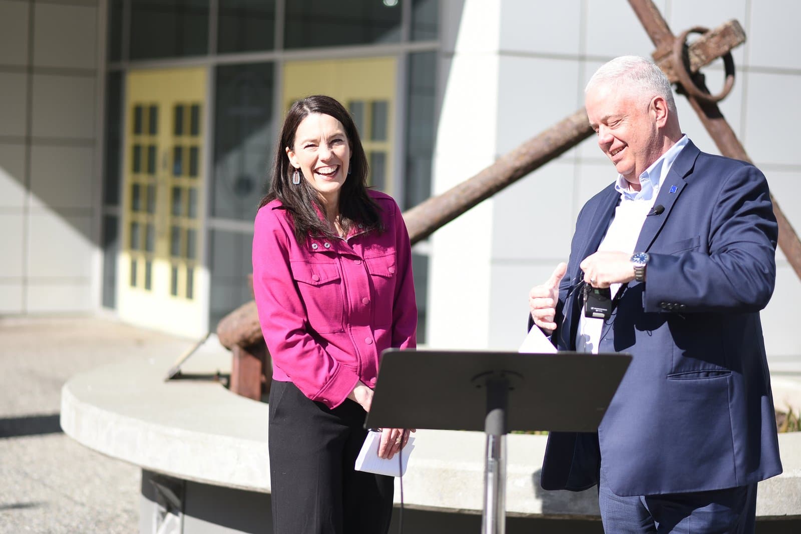 Bill Popp and Suzanne LaFrance stand together outdoors during an endorsement event in Anchorage, Alaska, on a sunny spring day.