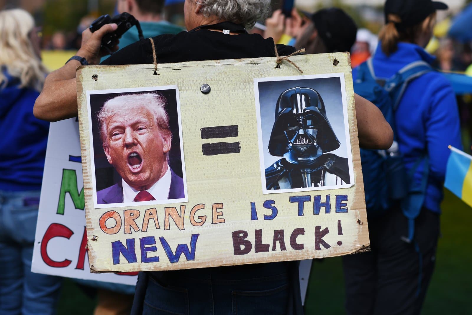 A protester holds a handmade sign comparing Donald Trump to Darth Vader during a pro-Ukraine demonstration in downtown Anchorage, Alaska.