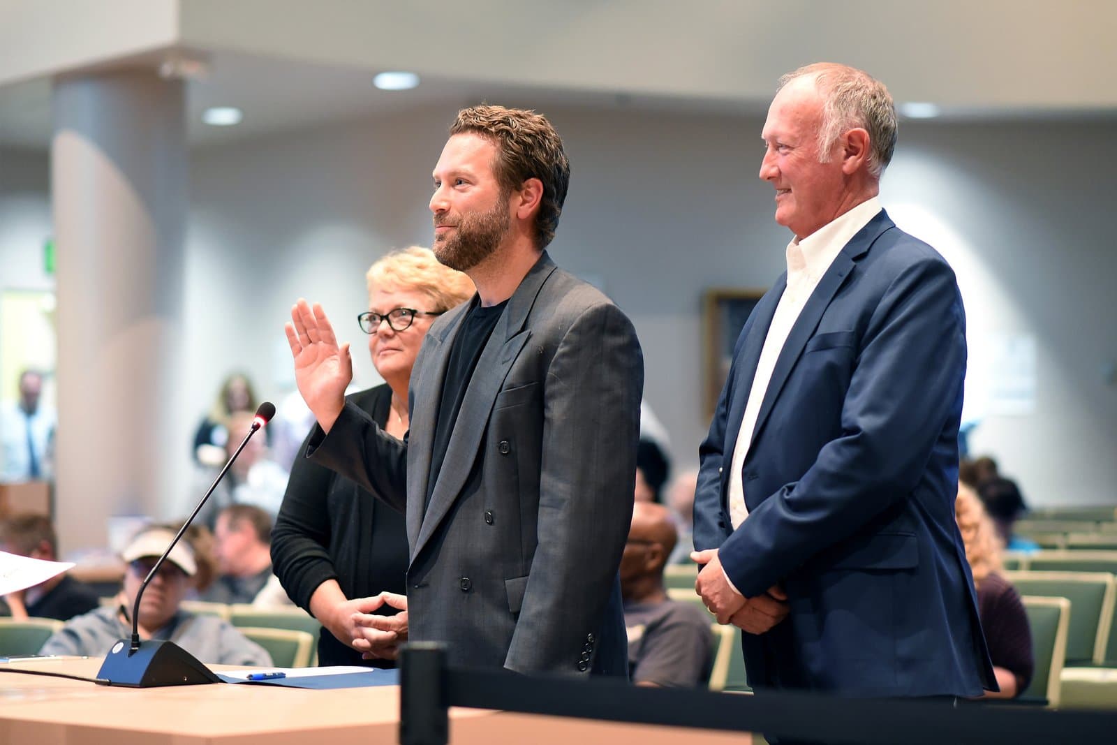 A man takes an oath of office with his hand raised during an Anchorage Assembly meeting in July 2022.