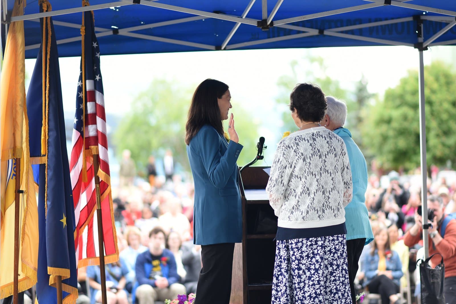 Suzanne LaFrance takes the oath of office as mayor of Anchorage during an outdoor public ceremony held under a blue canopy.