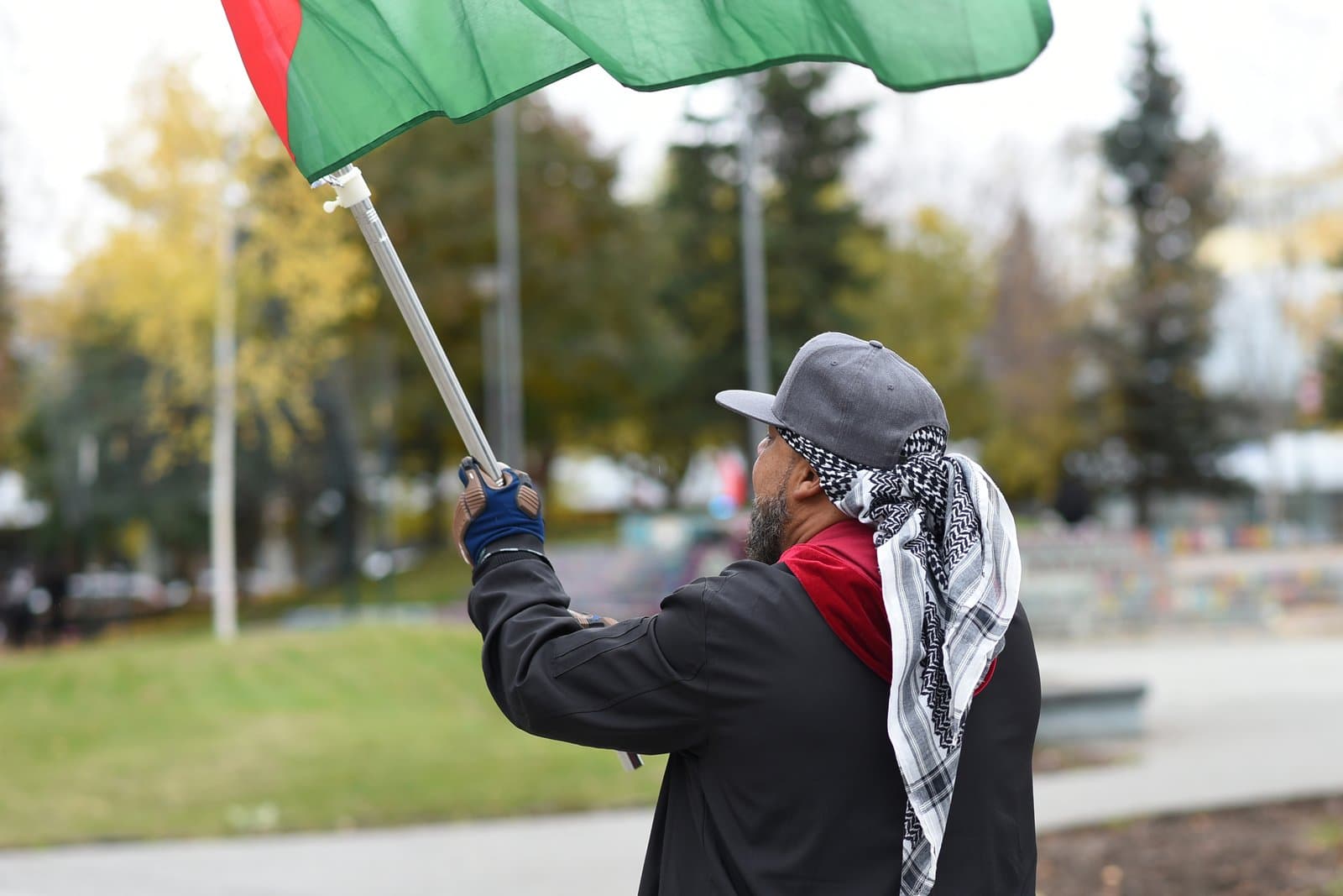 A protester holds a flag while participating in a Party for Socialism and Liberation demonstration in downtown Anchorage, Alaska.